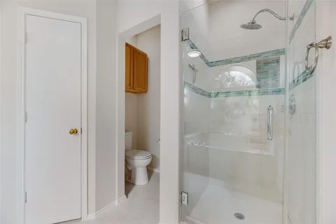 a spacious bathroom with a tub sink and mirror