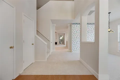 a view of an entryway with wooden floor