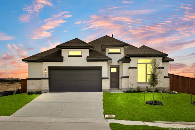 a front view of a house with a yard
