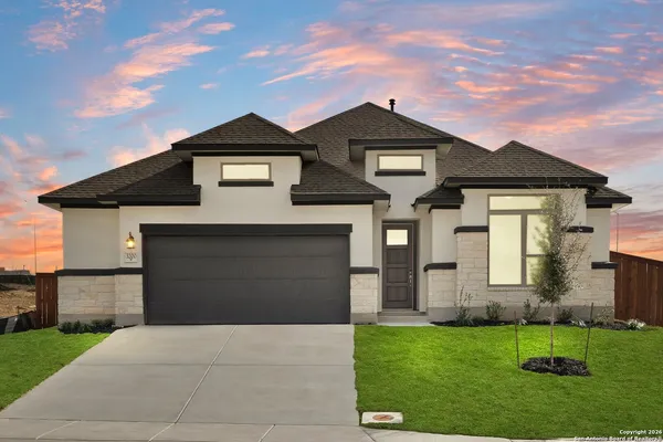 a front view of a house with a yard and garage