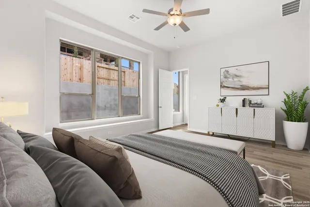 a bedroom with a large bed couch and a window