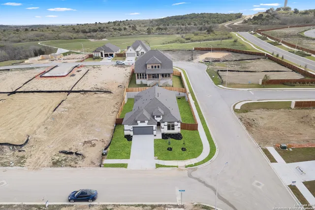 an aerial view of a house with a swimming pool
