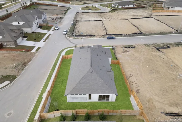 an aerial view of a house with a swimming pool