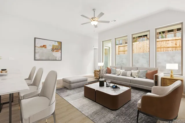 a living room with furniture and a large window with garden view