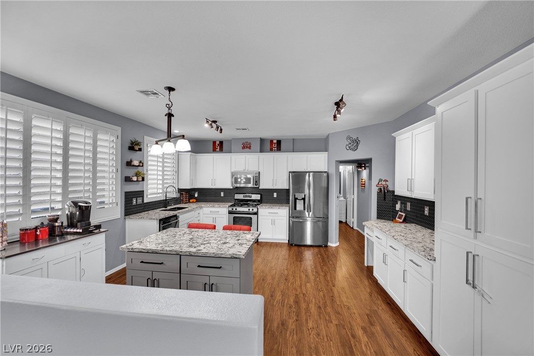 1724 Millstream Way Henderson, NV 89074 - Photo 16 of 60 A well-lit kitchen with sleek appliances and abundant storage solutions, offering both practicality and modern charm.