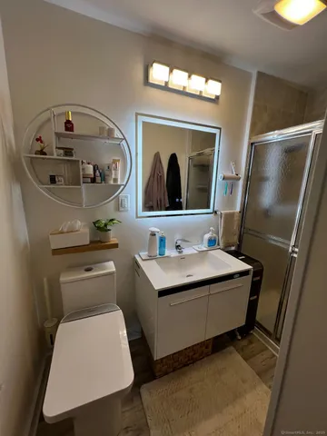 a bathroom with a toilet a sink and a mirror