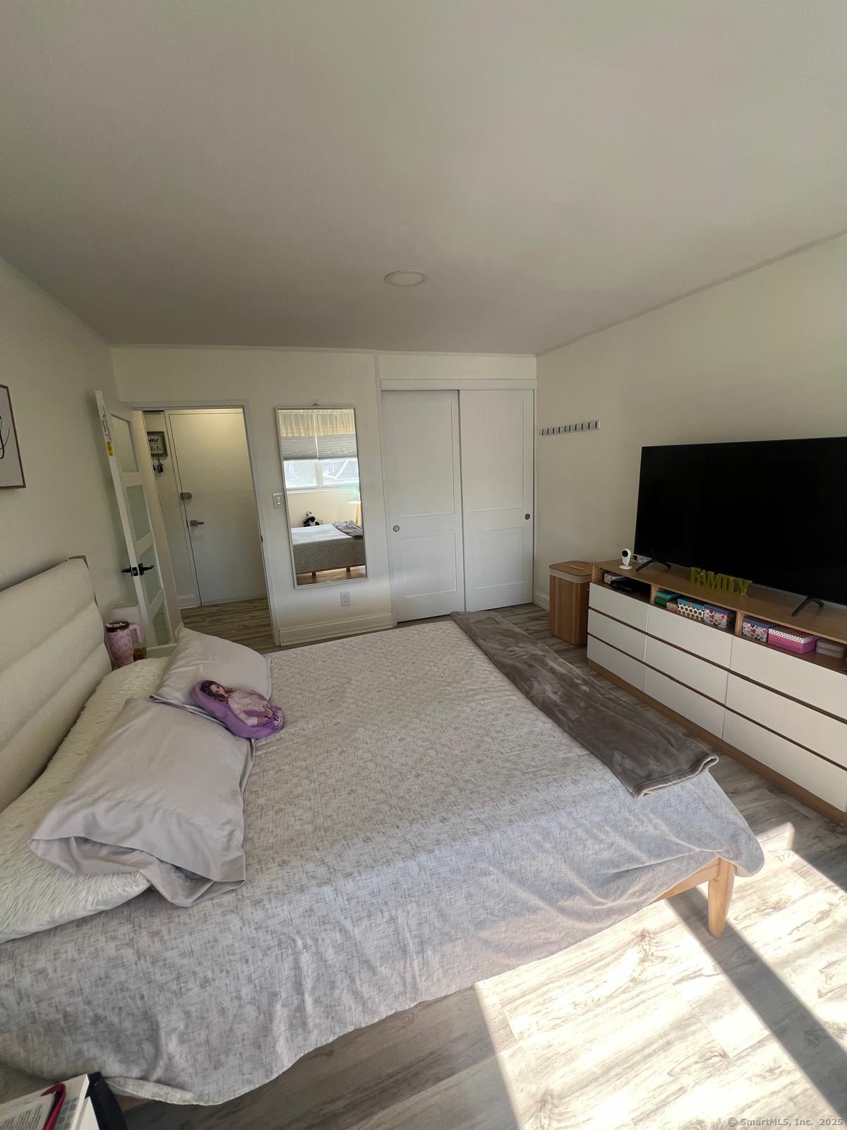 2370 North Avenue, Unit 3F Bridgeport, CT 06604 - Photo 14 of 25 a bedroom with a bed and a flat screen tv