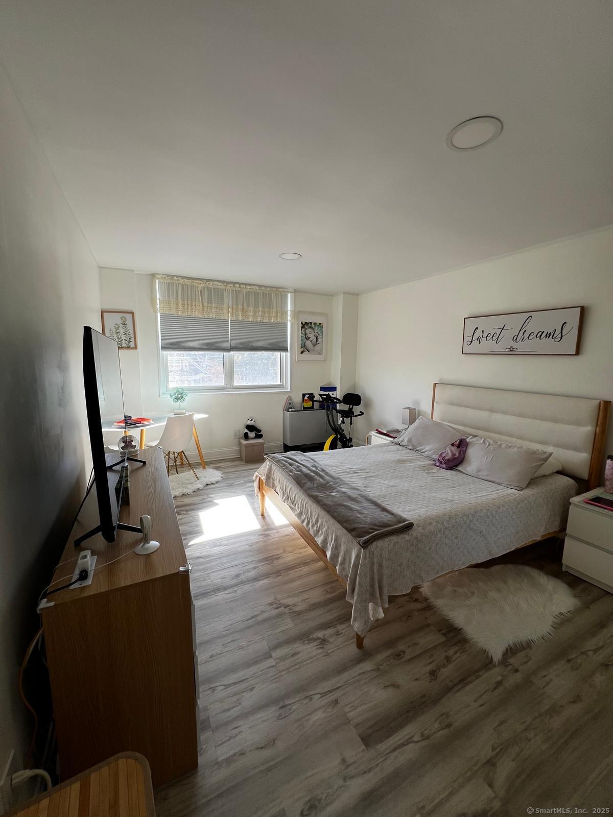 2370 North Avenue, Unit 3F Bridgeport, CT 06604 - Photo 16 of 25 a bed room with furniture and a window