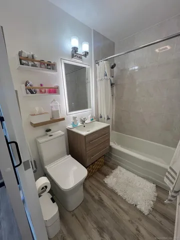 a bathroom with a sink toilet tub and shower