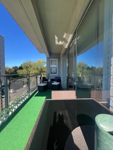 a view of a balcony with yard