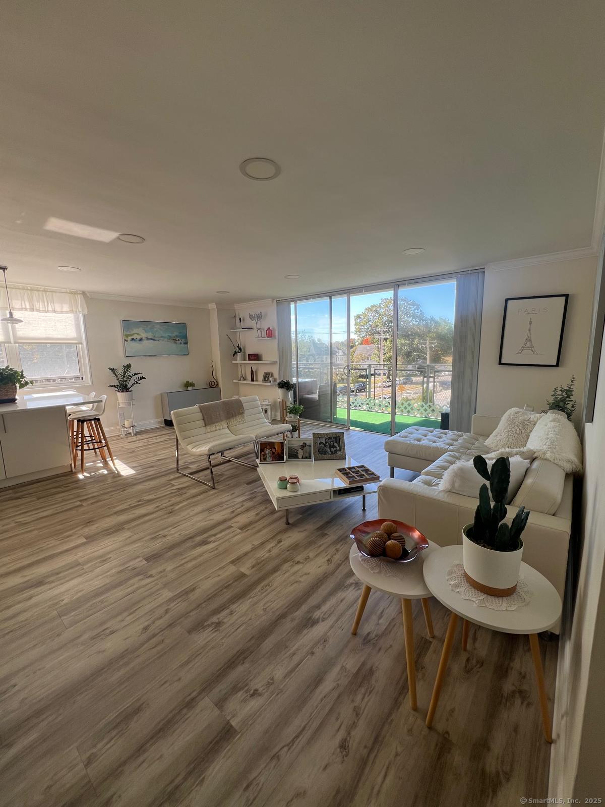 2370 North Avenue, Unit 3F Bridgeport, CT 06604 - Photo 2 of 25 a living room with furniture and a large window