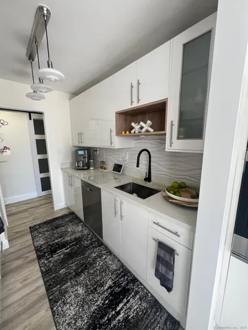 a kitchen with stainless steel appliances a stove a sink and a refrigerator