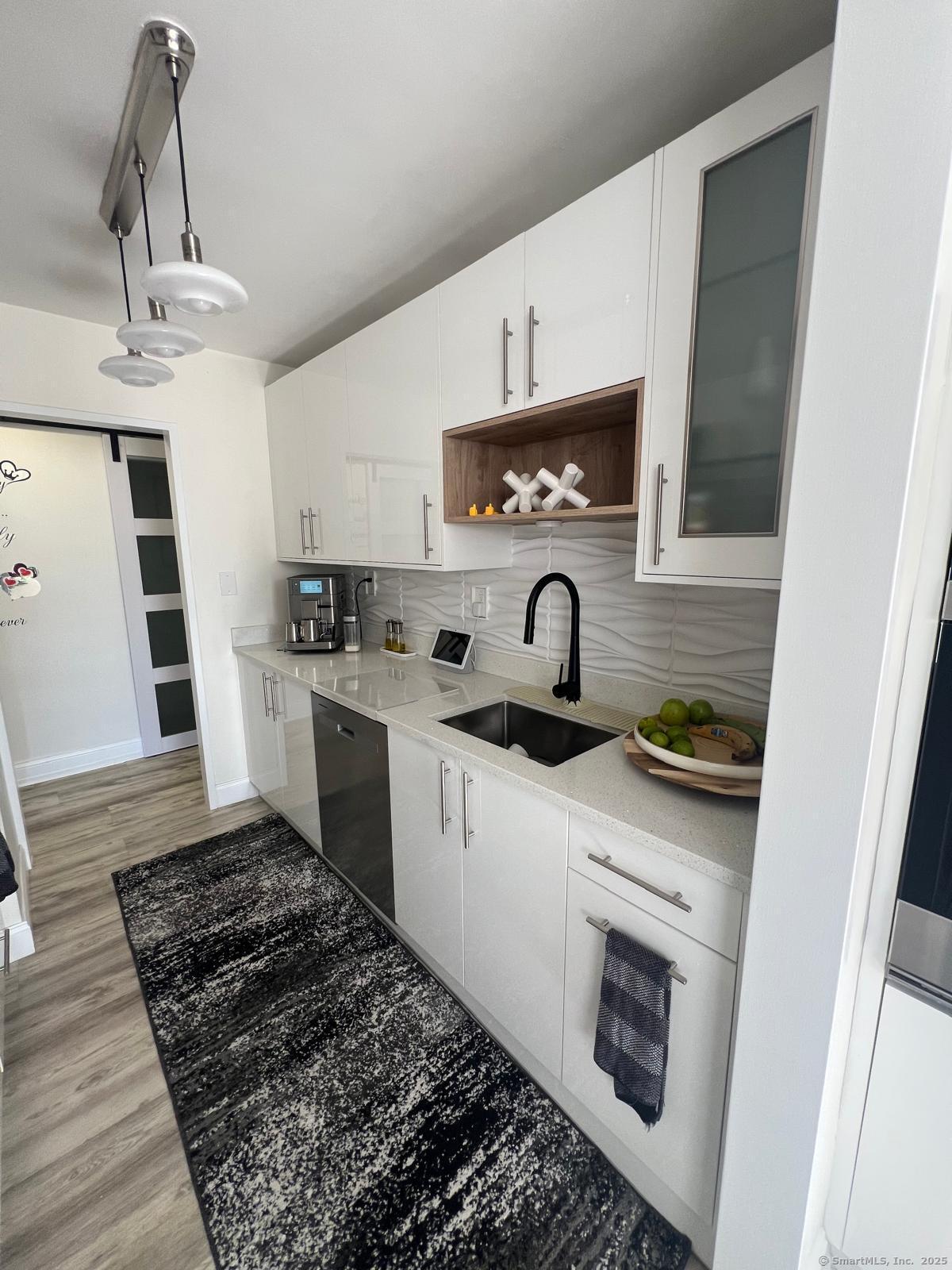 2370 North Avenue, Unit 3F Bridgeport, CT 06604 - Photo 7 of 25 a kitchen with stainless steel appliances a stove a sink and a refrigerator