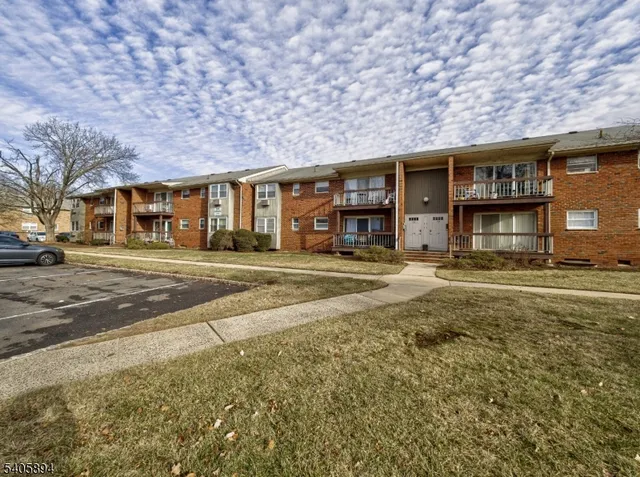 a front view of a building with a garden