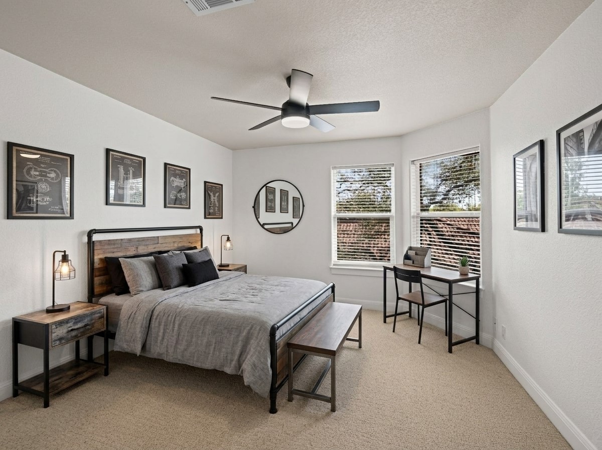 11 Treehaven Lane The Hills, TX 78738 - Photo 23 of 40 a bedroom with a bed a table and chair with a large mirror next to a window