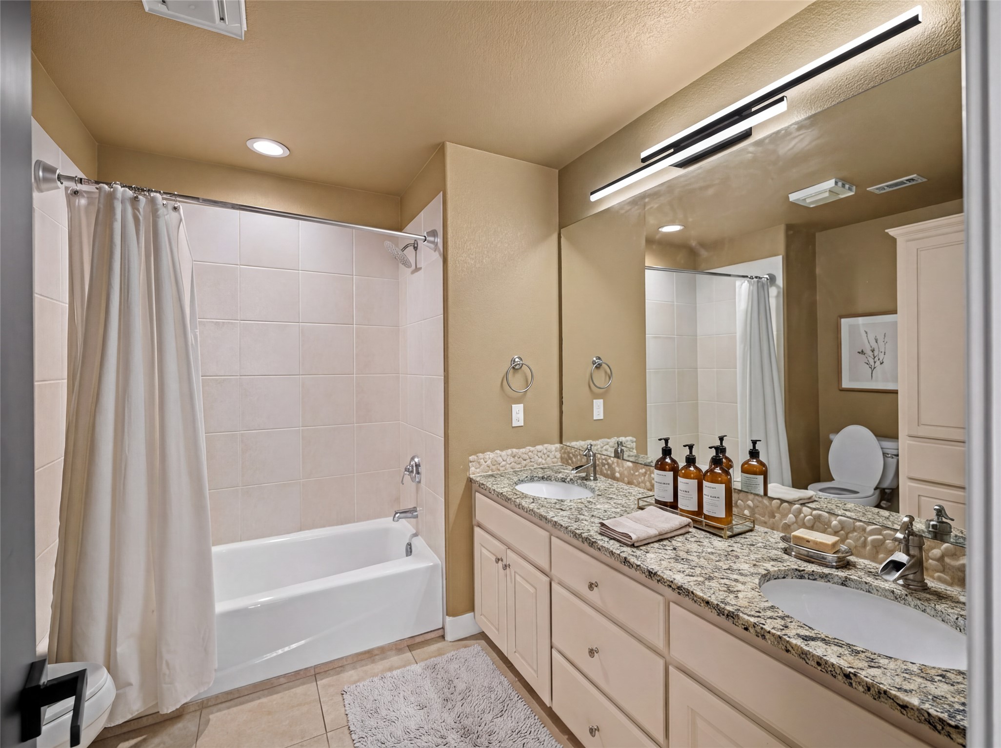 11 Treehaven Lane The Hills, TX 78738 - Photo 25 of 40 a bathroom with a granite countertop sink mirror and a bath tub