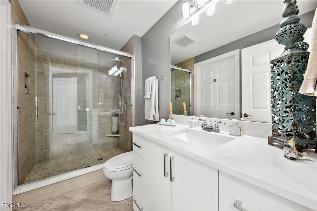 2745 First Street, Unit 1602 Fort Myers, FL 33916 - Photo 26 of 49 a bathroom with a sink a toilet and shower