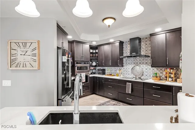 a kitchen with stainless steel appliances kitchen island granite countertop a refrigerator and a stove top oven