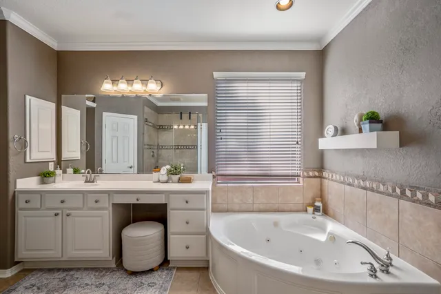 a bathroom with a granite countertop sink mirror bathtub and shower