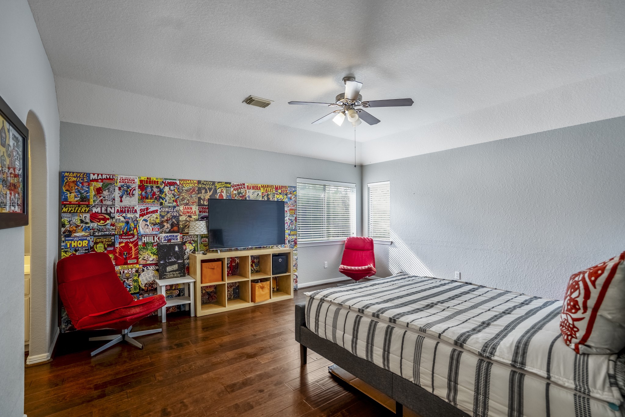 10203 Earlington Manor Drive Spring, TX 77379 - Photo 23 of 50 a bedroom with a bed a books bucket with a desk and chair