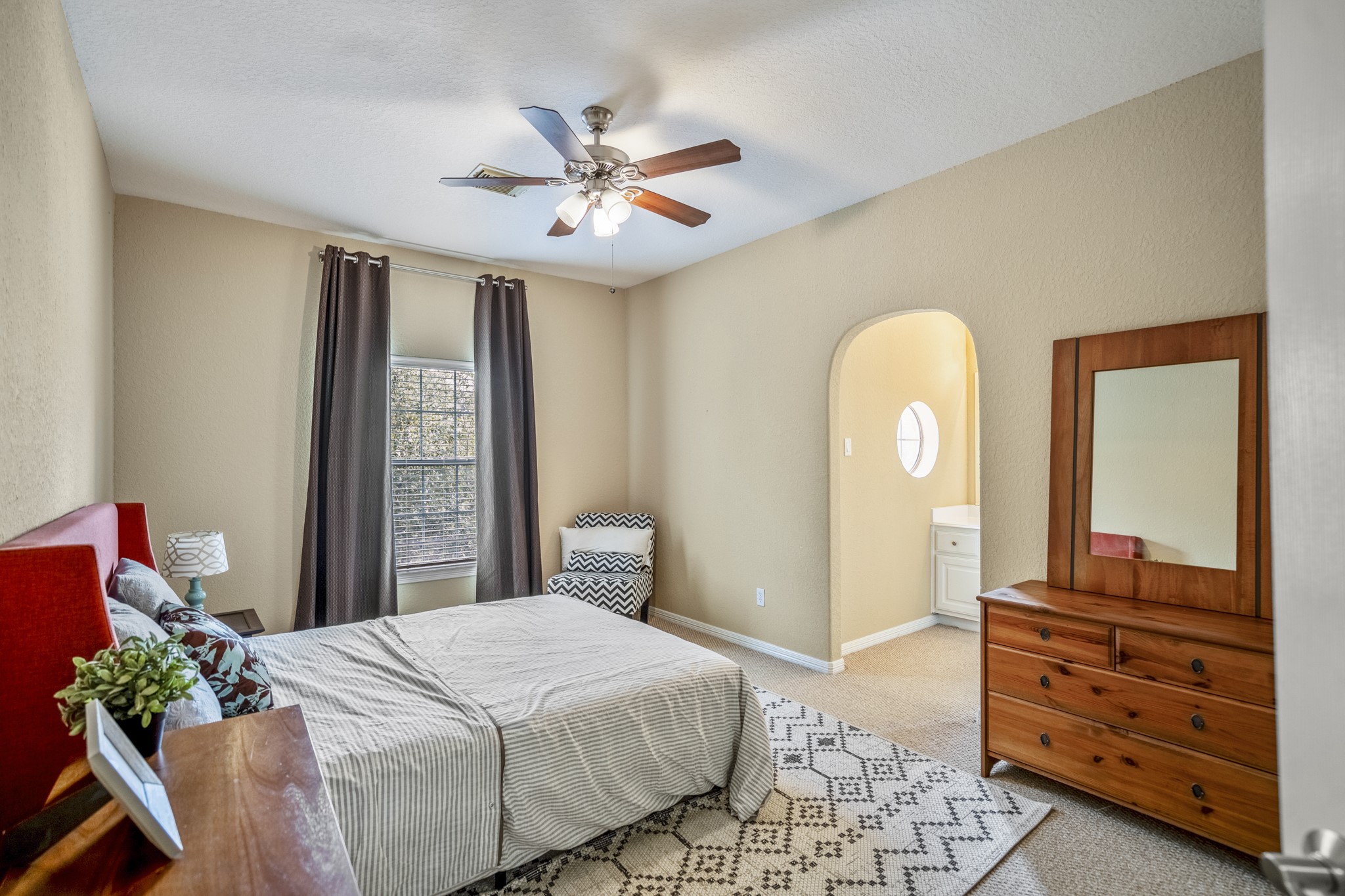 10203 Earlington Manor Drive Spring, TX 77379 - Photo 24 of 50 a bedroom with a bed and a chandelier