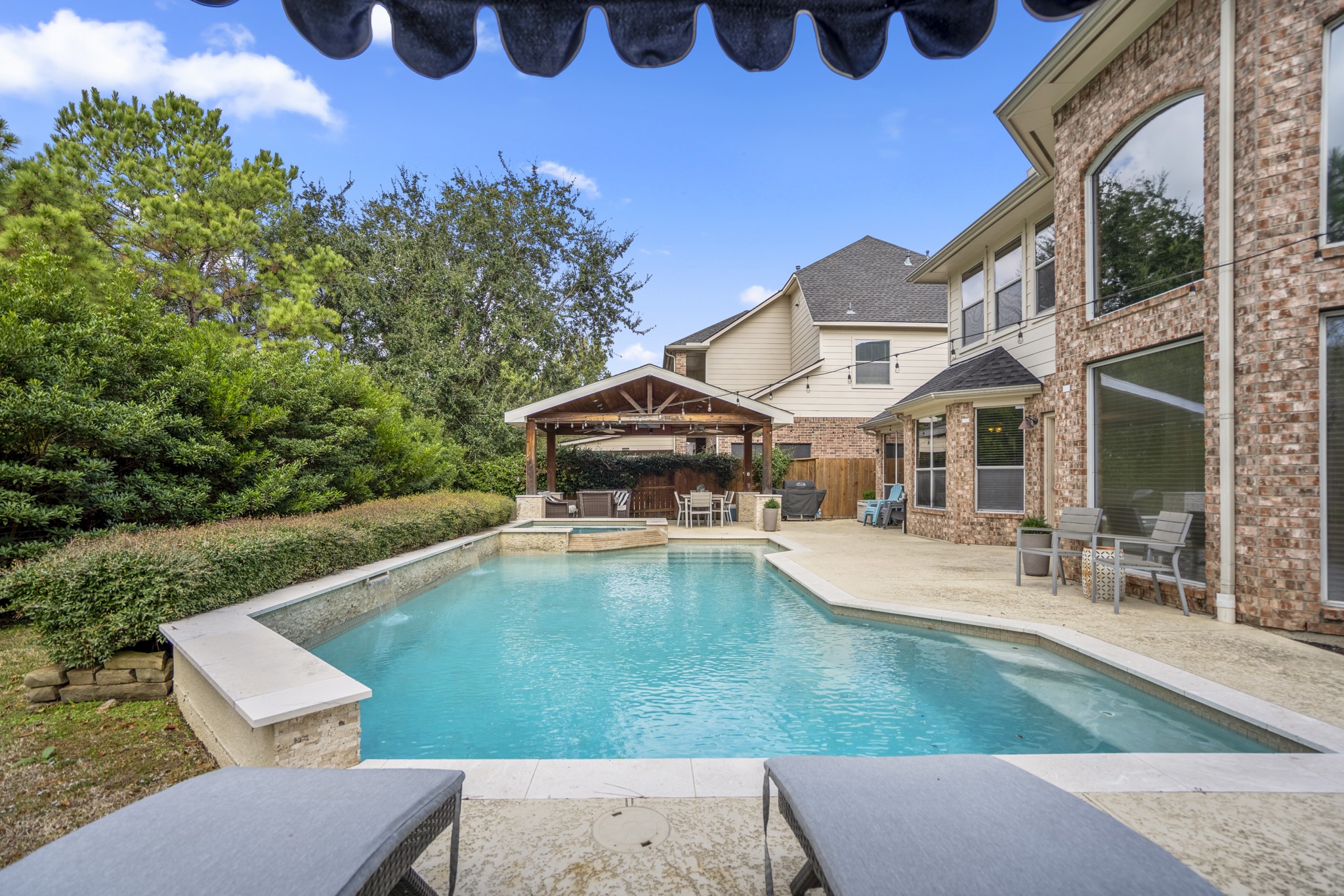 10203 Earlington Manor Drive Spring, TX 77379 - Photo 31 of 50 a view of a house with pool and chairs