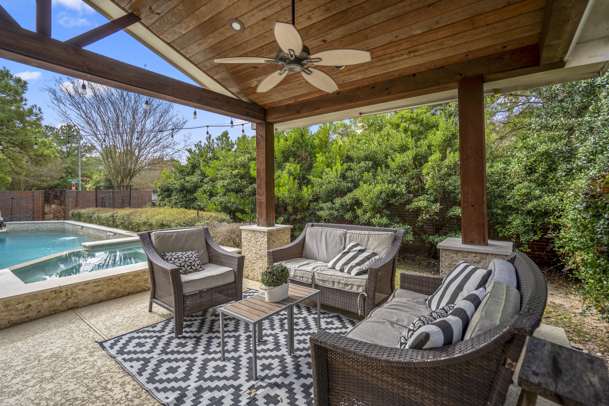 10203 Earlington Manor Drive Spring, TX 77379 - Photo 33 of 50 a view of patio with lawn chairs and couches with wooden floor and fence