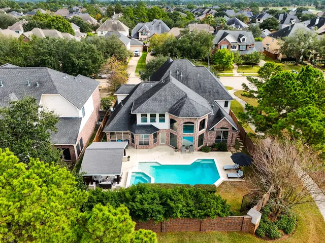an aerial view of residential houses with yard