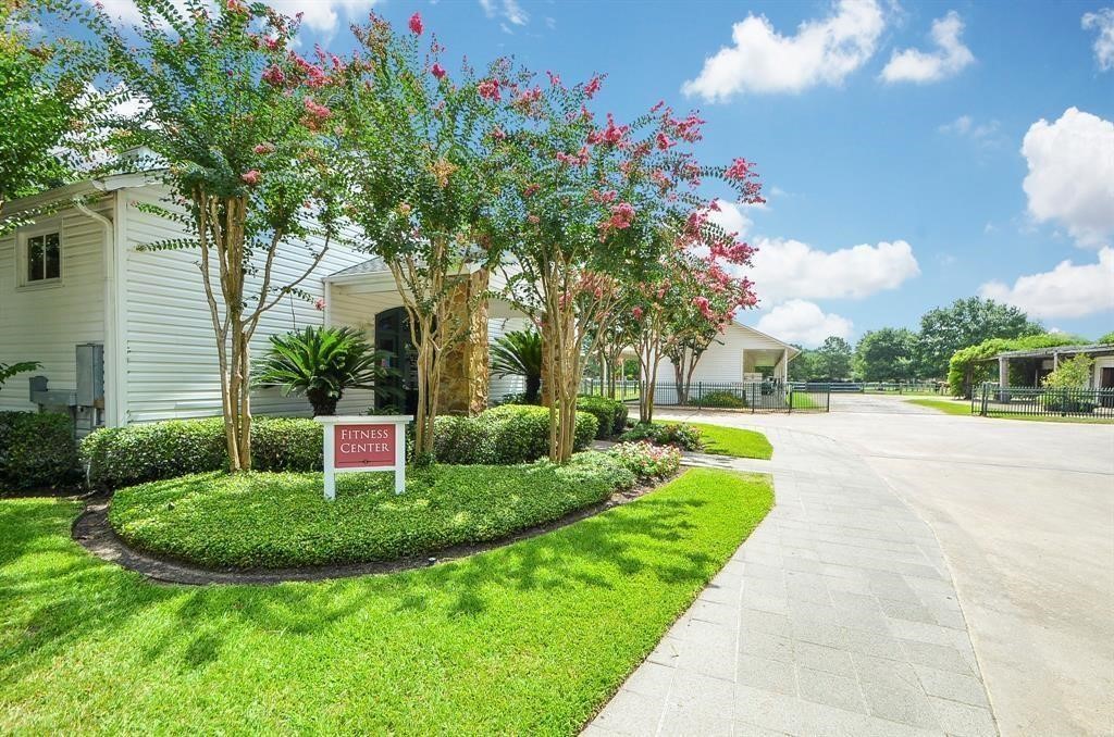 10203 Earlington Manor Drive Spring, TX 77379 - Photo 46 of 50 a view of a house with a big yard plants and large trees