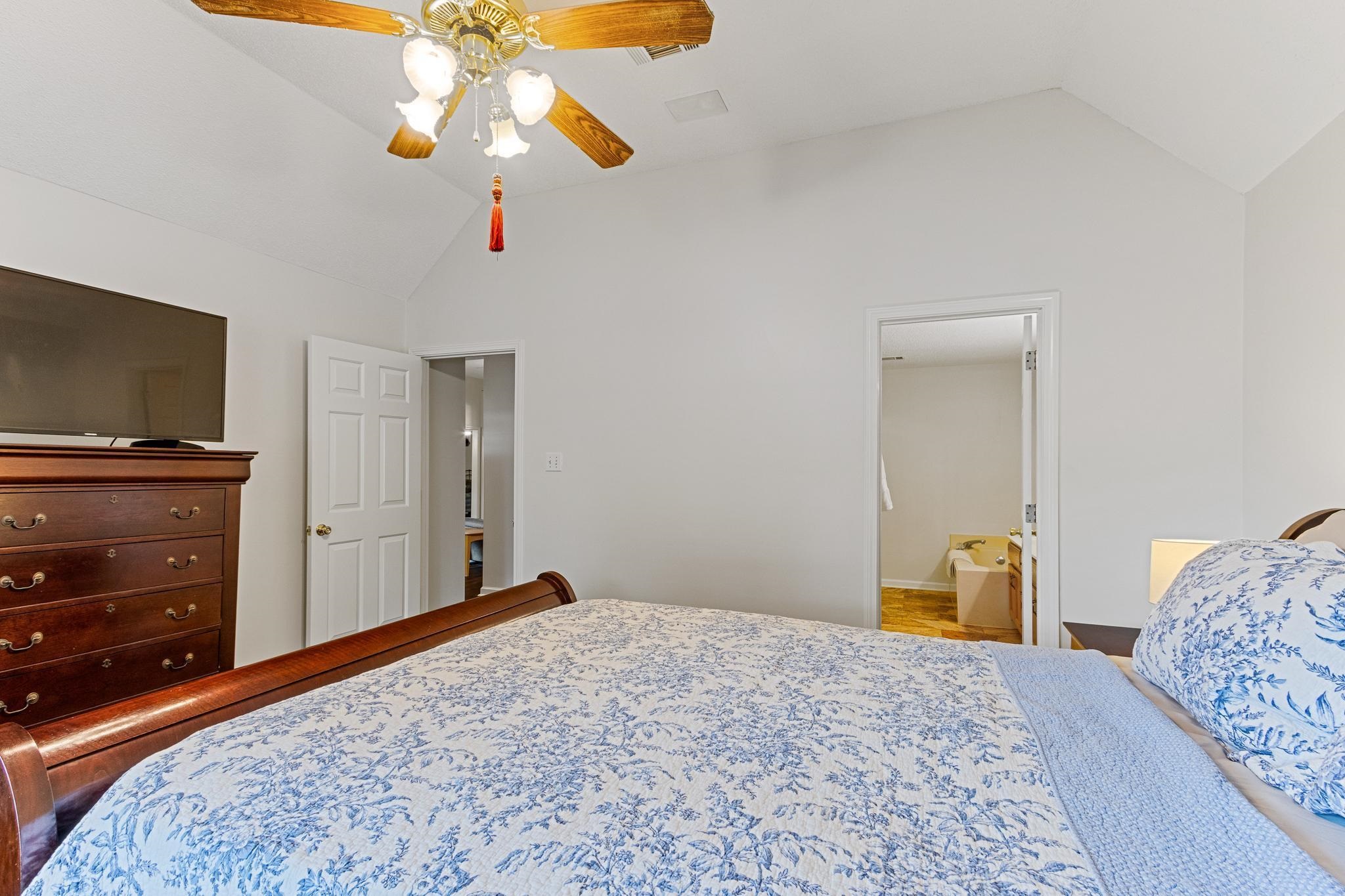 1479 Wolf Ridge Drive Collierville, TN 38017 - Photo 20 of 36 a bedroom with a bed and a flat tv screen on dresser