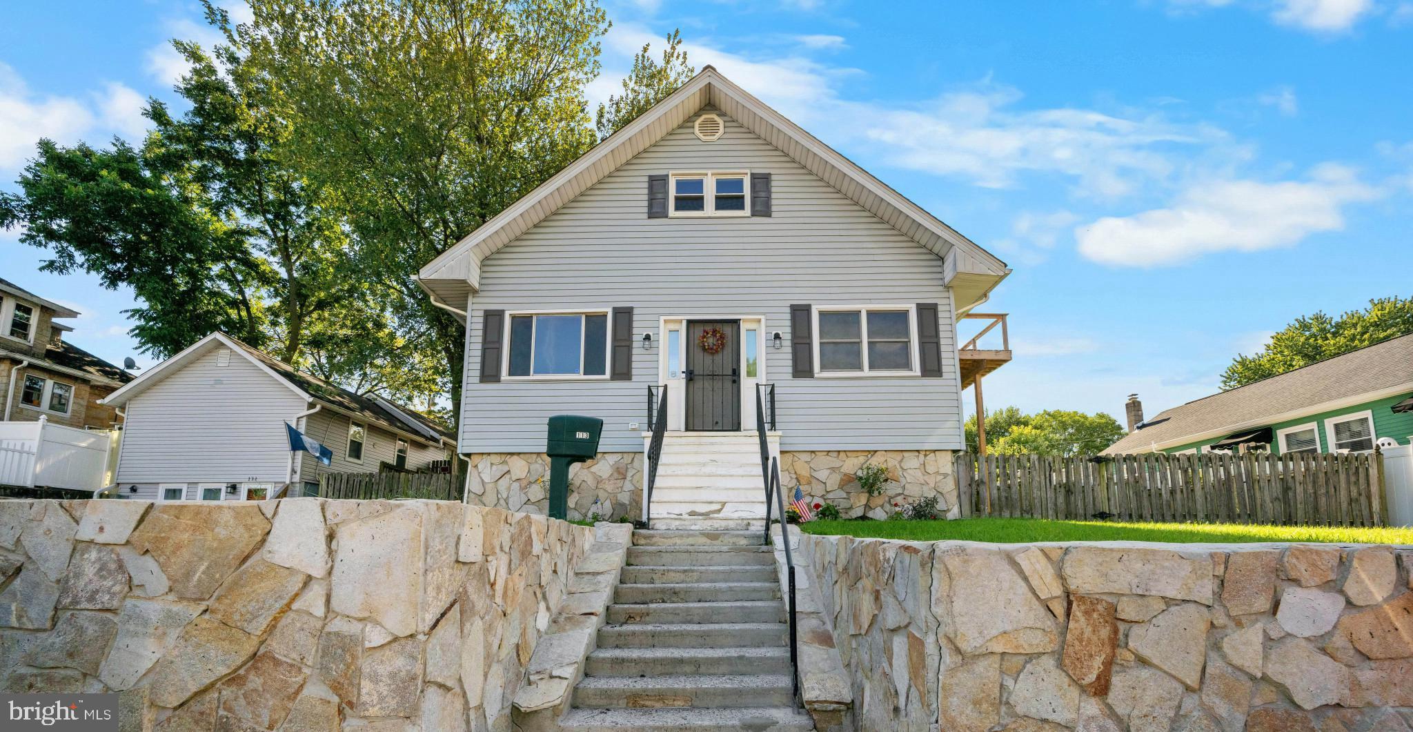 a view of a house with wooden fence