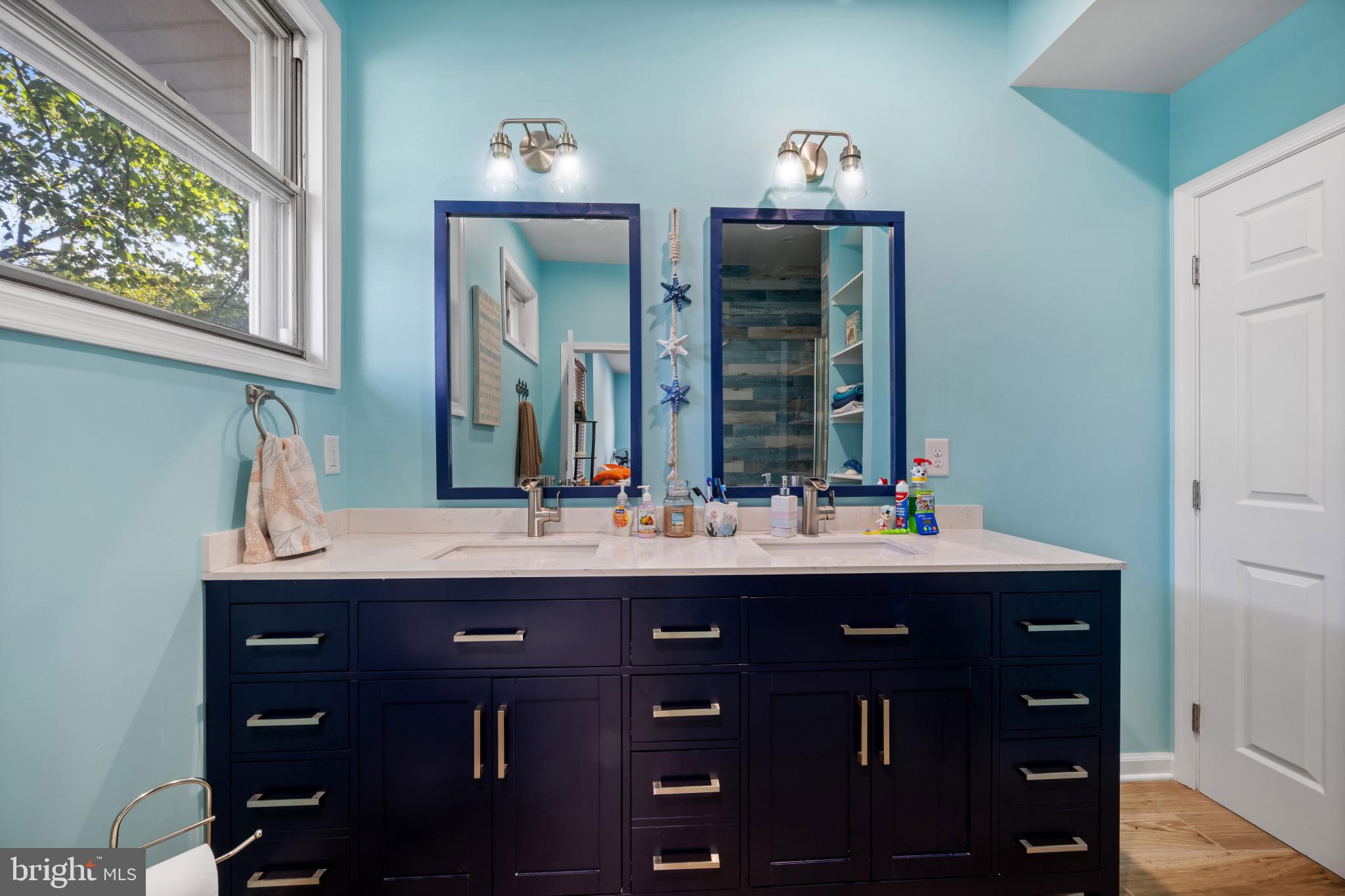 113 West Edgevale Road Baltimore, MD 21225 - Photo 15 of 41 a room with two sink and a mirror