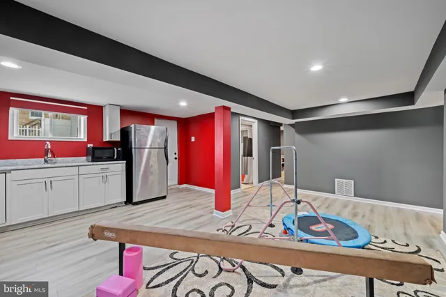 a kitchen with stainless steel appliances kitchen island granite countertop a refrigerator and microwave