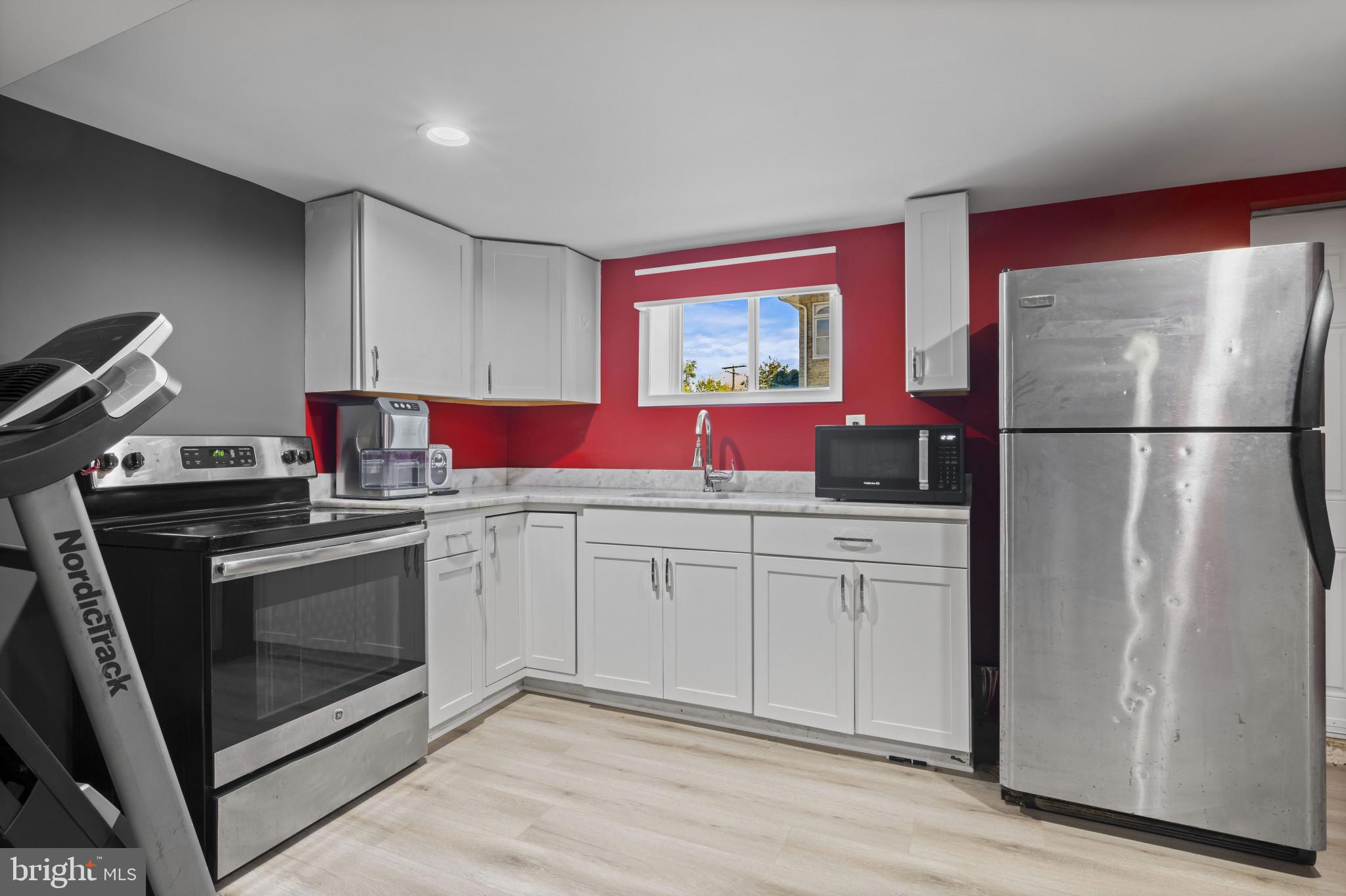 113 West Edgevale Road Baltimore, MD 21225 - Photo 32 of 41 a kitchen with stainless steel appliances a stove a refrigerator and cabinets