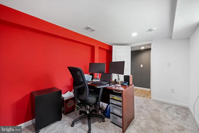 a work room with furniture and rug