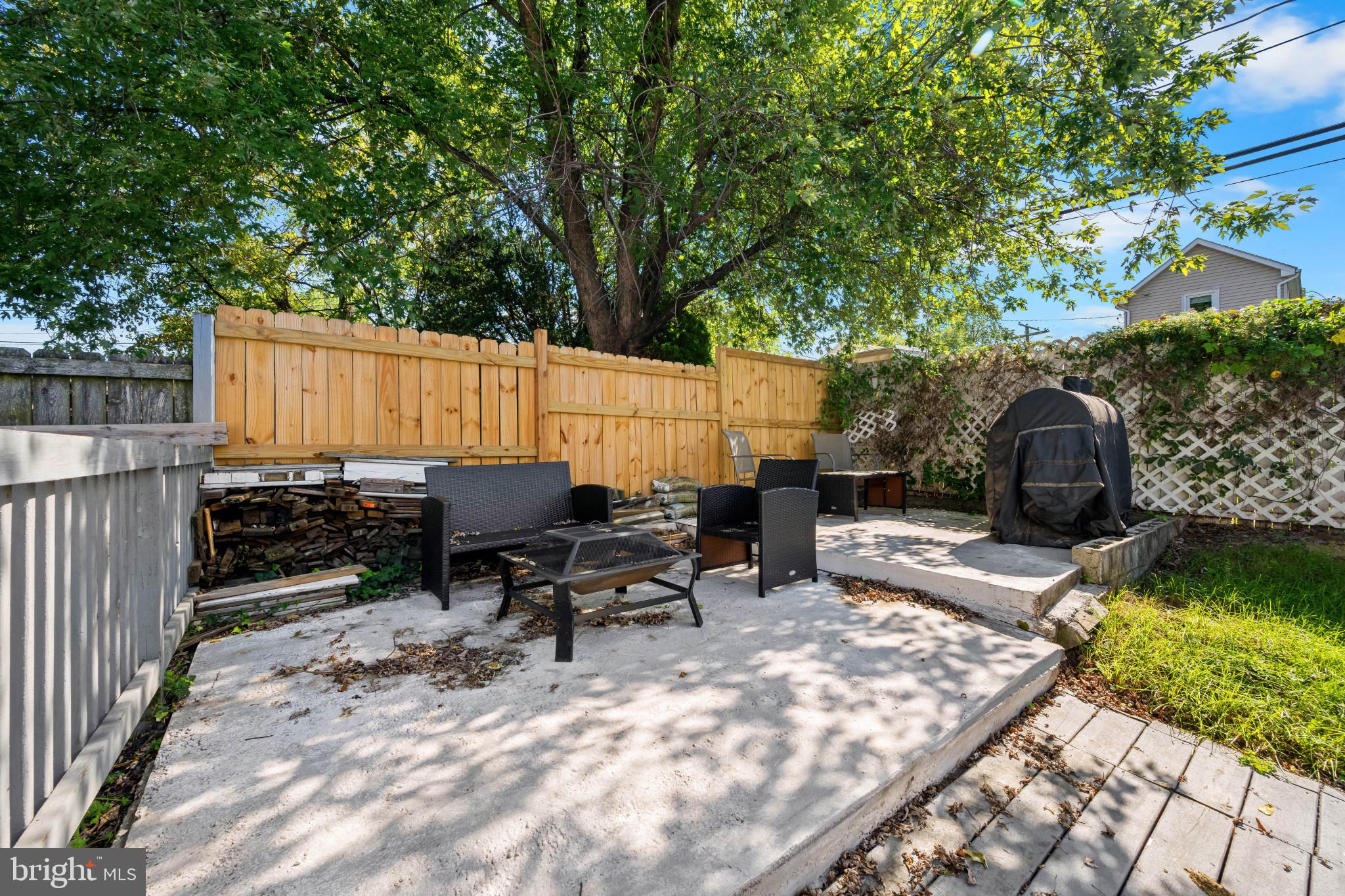 113 West Edgevale Road Baltimore, MD 21225 - Photo 38 of 41 a view of a patio with a table and chairs