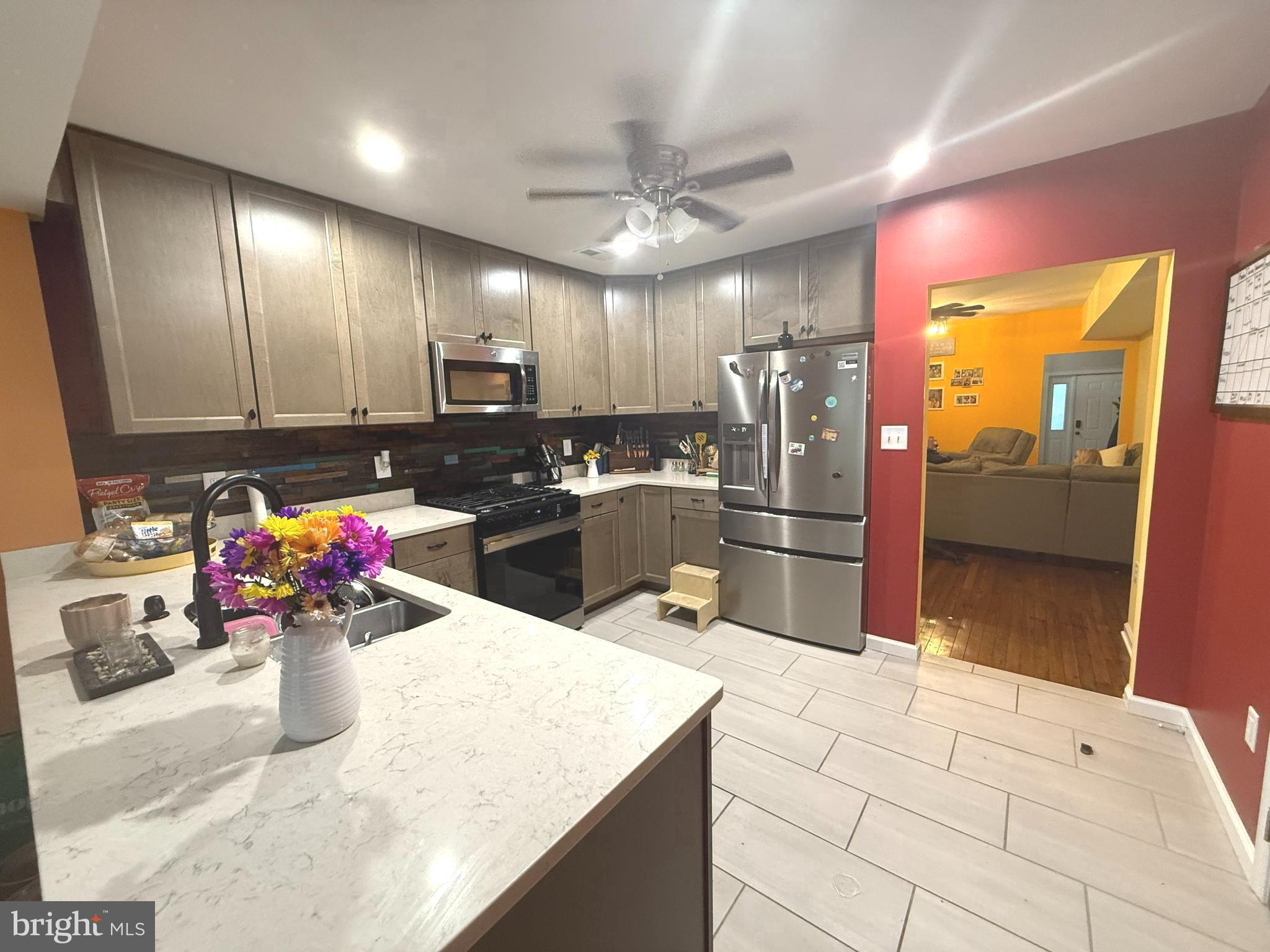 113 West Edgevale Road Baltimore, MD 21225 - Photo 8 of 41 a kitchen with stainless steel appliances kitchen island granite countertop a refrigerator a stove and a sink
