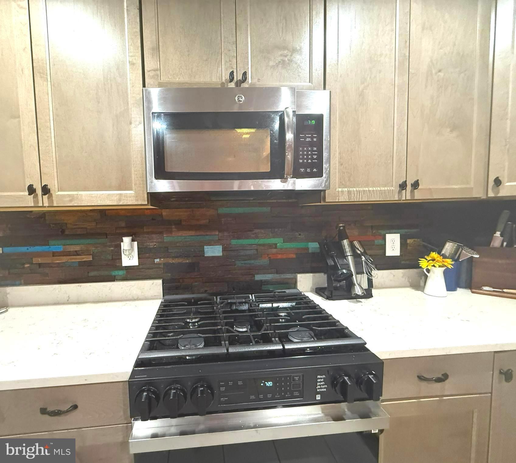 113 West Edgevale Road Baltimore, MD 21225 - Photo 9 of 41 a kitchen with granite countertop a stove a sink and a microwave