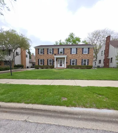 a front view of building with yard and green space