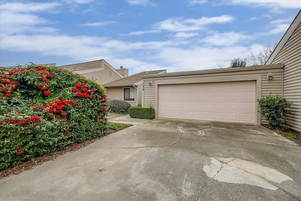 a front view of house with flower around