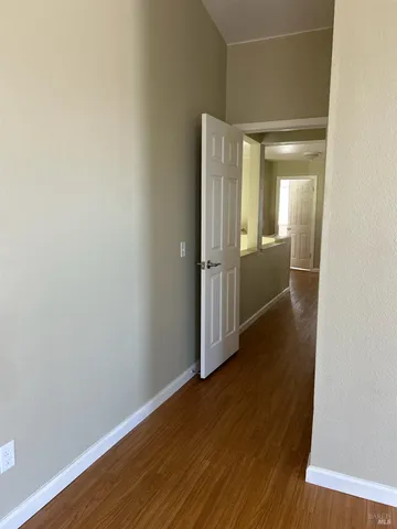 a view of hallway with wooden floor