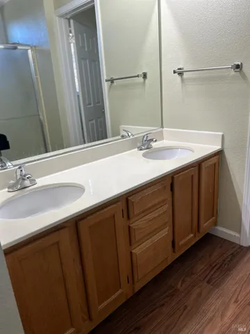 a bathroom with a double vanity sink and a mirror