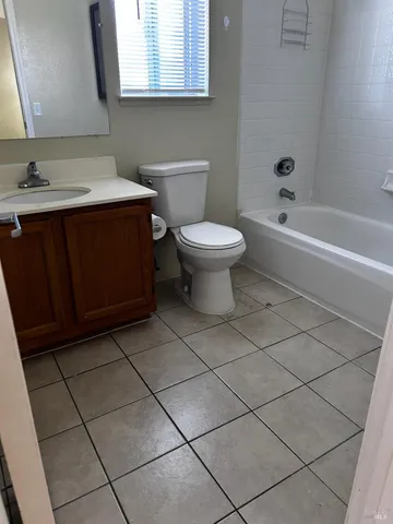 a bathroom with a sink toilet and mirror