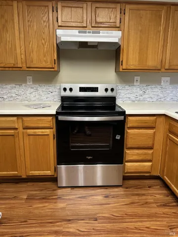 a kitchen with granite countertop a stove and a sink