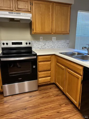a kitchen with granite countertop a stove and a sink