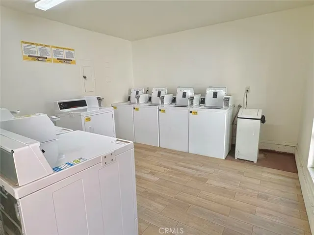 a view of a patio with a table and chairs under an umbrella