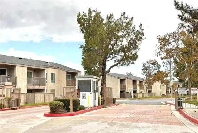 a front view of a building with street view and trees