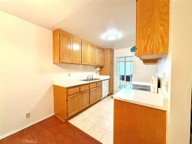 a kitchen with granite countertop a sink a stove and a microwave