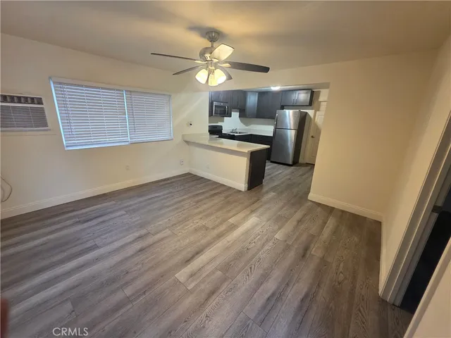 a kitchen with a sink dishwasher a refrigerator and wooden floor