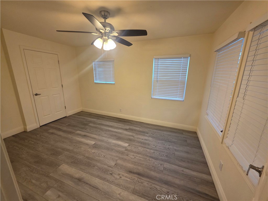 533 East 9th Stockton, CA 95206 - Photo 5 of 6 a view of an empty room with wooden floor and a window